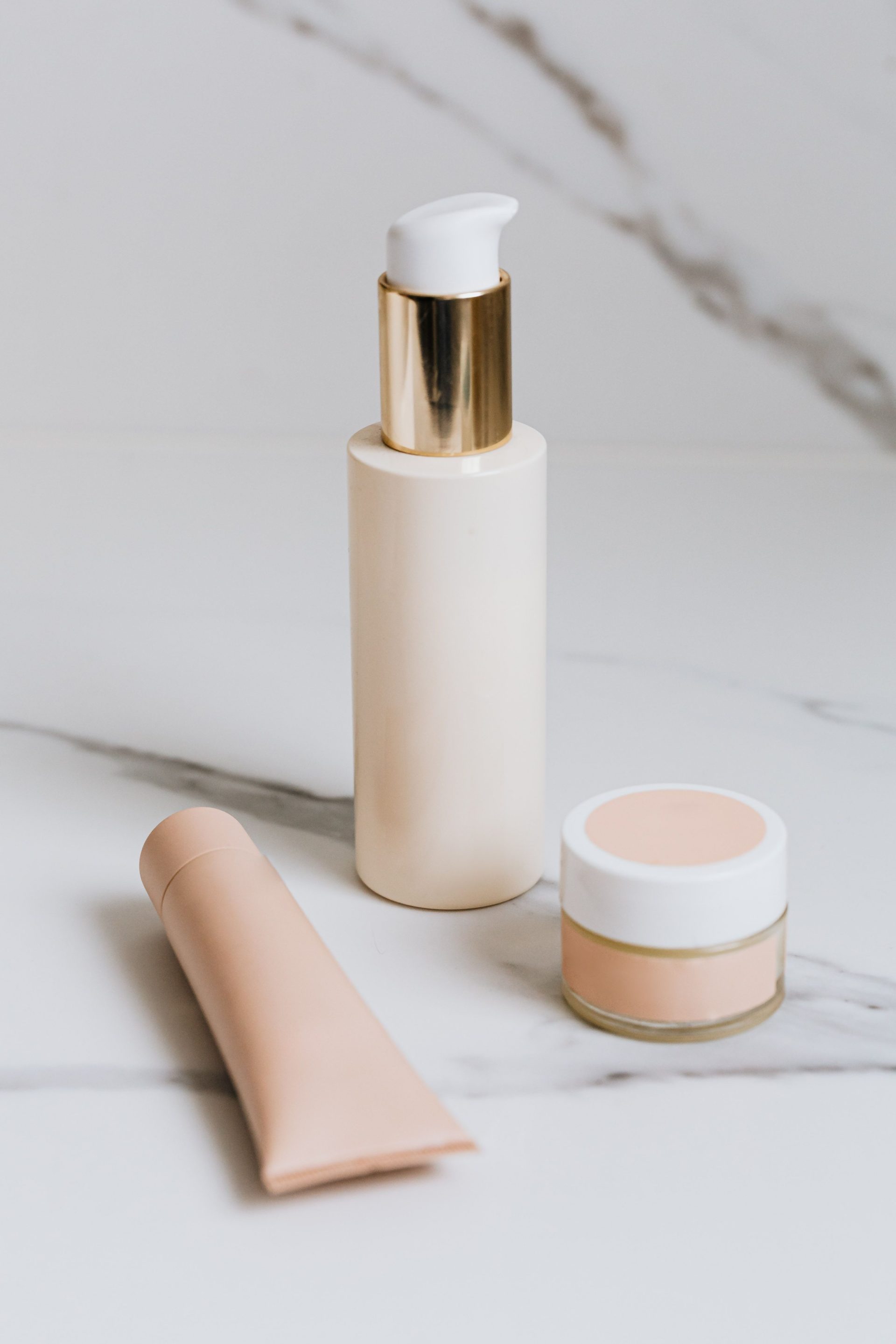 Luxurious skincare products elegantly arranged on a marble surface, showcasing beauty essentials.